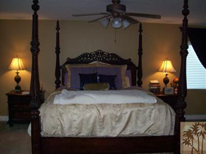37454 Haweswater Road Indio, CA 92203 - Photo 15 of 25 a bedroom with a bed and a lamp