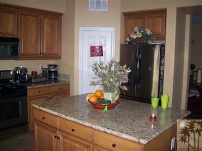 37454 Haweswater Road Indio, CA 92203 - Photo 19 of 25 a kitchen with stainless steel appliances granite countertop a sink a stove and cabinets