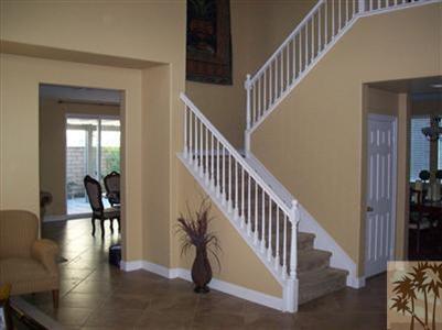 37454 Haweswater Road Indio, CA 92203 - Photo 2 of 25 a view of staircase and dining room with wooden floor and a chandelier