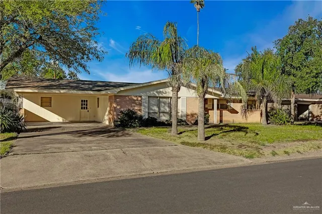 a view of a house with a yard and garage