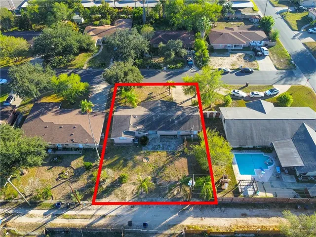 an aerial view of a houses with swimming pool