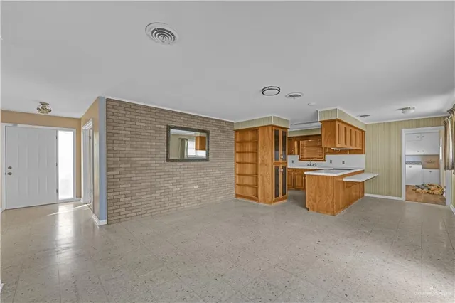 a view of a kitchen with furniture and wooden floor