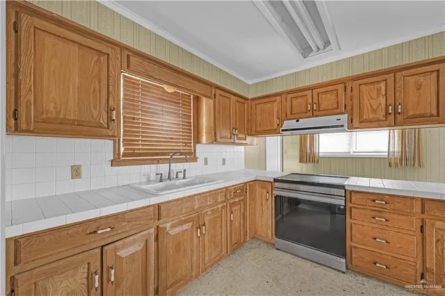 a kitchen with stainless steel appliances granite countertop a refrigerator and cabinets