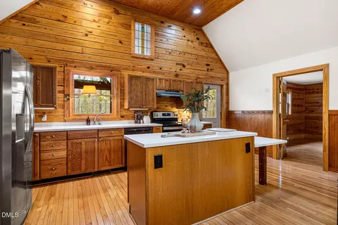 a kitchen with stainless steel appliances granite countertop a sink a stove and a microwave
