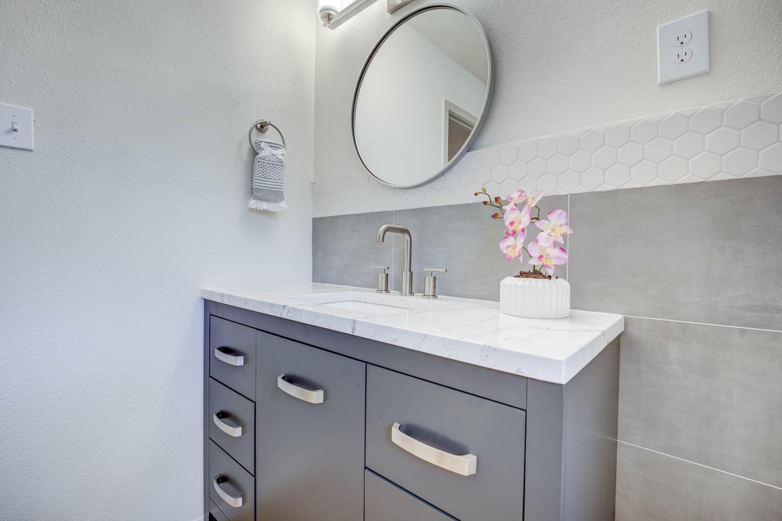 2101 64th Street Lubbock, TX 79412 - Photo 25 of 30 a bathroom with a sink and a mirror