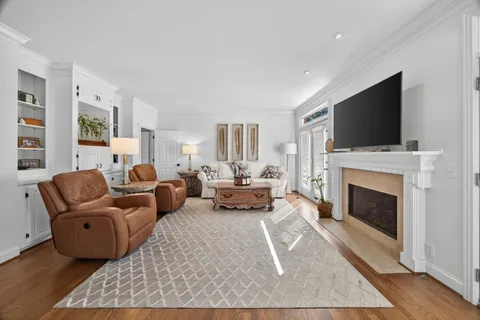 a living room with fireplace furniture and a flat screen tv