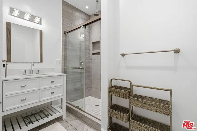 a bathroom with a mirror and a shower