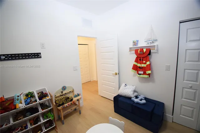 a bedroom with furniture and a flat screen tv