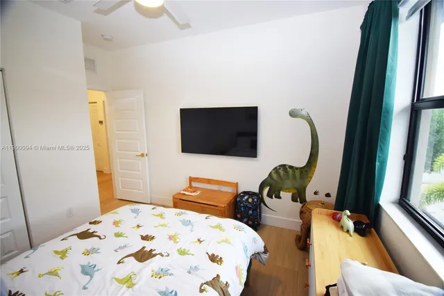 a bed sitting in a bedroom next to a window