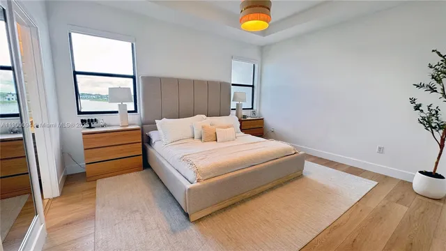 a bedroom with bed and a flat screen tv