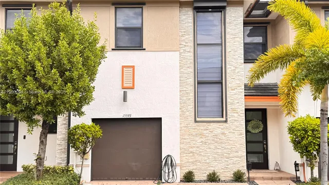 a front view of a house with garden