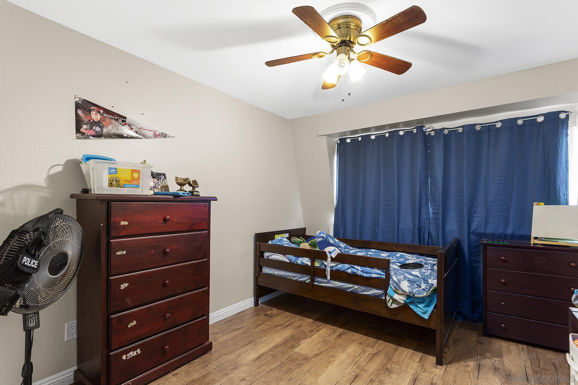 2810 Rosedale Place Spring Valley, CA 91977 - Photo 42 of 48 a bedroom with a dresser and a chandelier