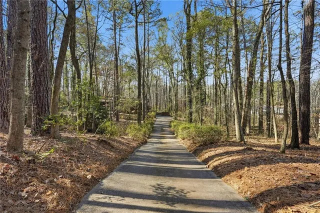 a view of a mini pool with a yard in front of it