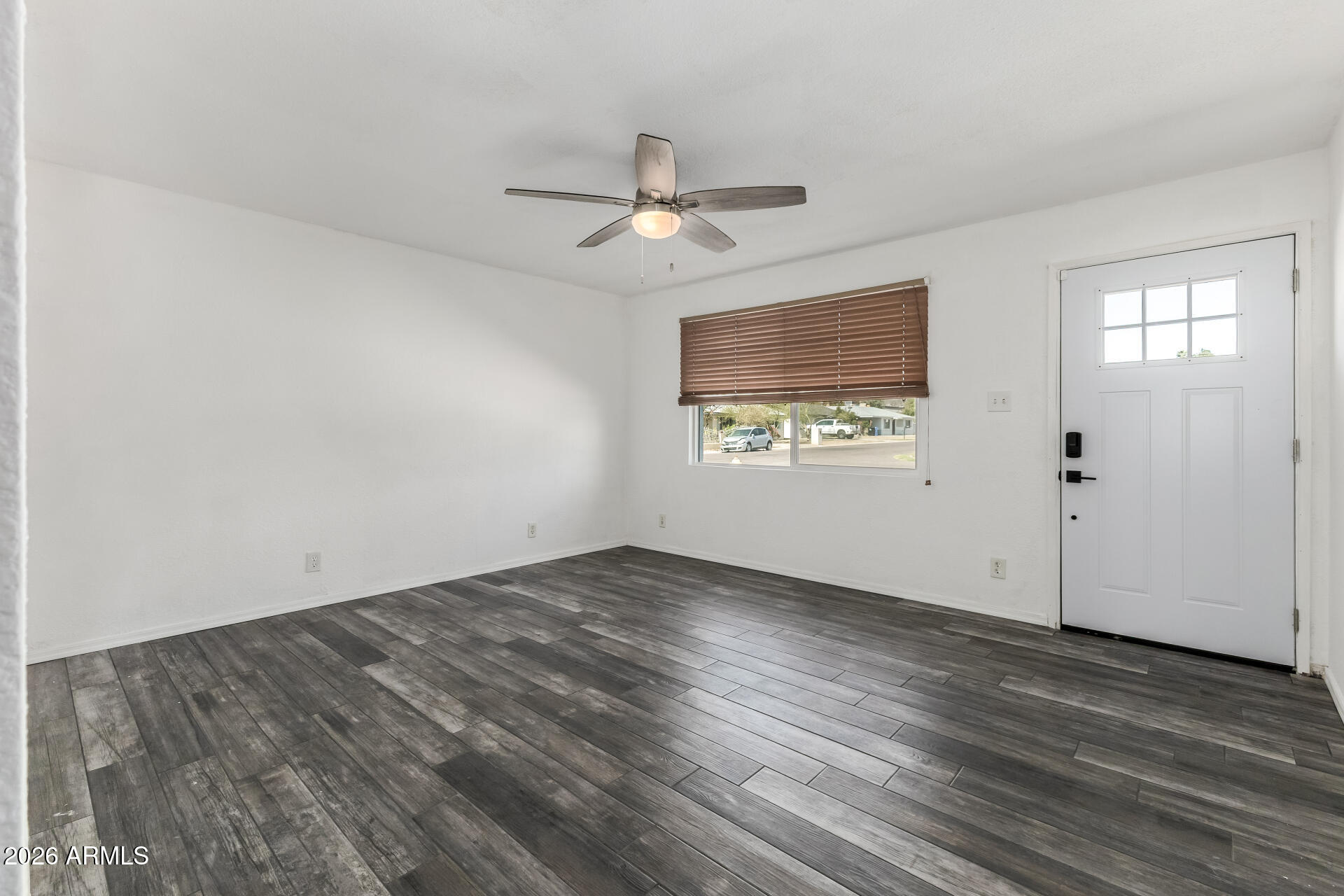 801 East Ruth Avenue Phoenix, AZ 85020 - Photo 11 of 35 an empty room with wooden floor ceiling fan and windows