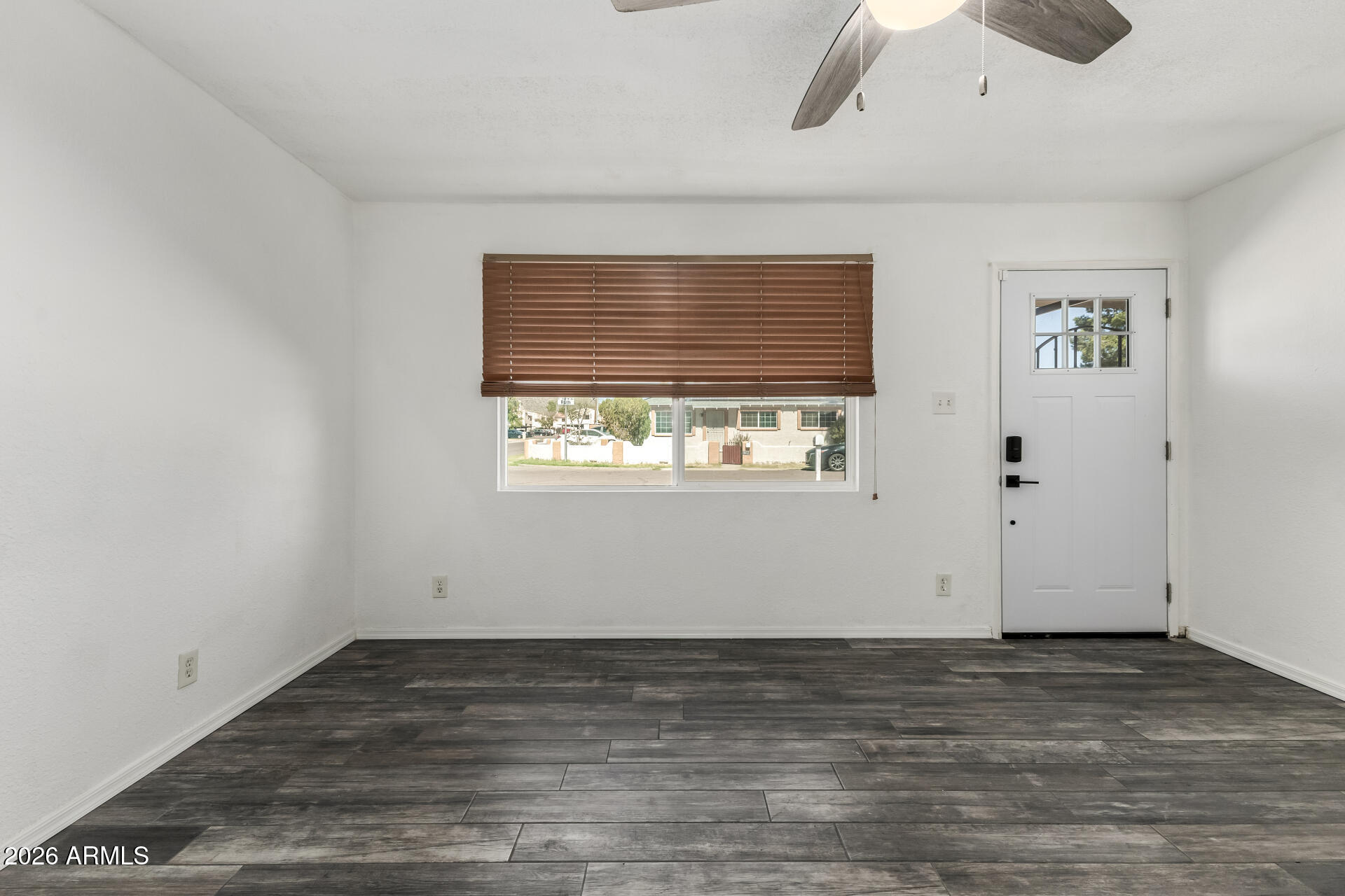 801 East Ruth Avenue Phoenix, AZ 85020 - Photo 13 of 35 an empty room with wooden floor and windows