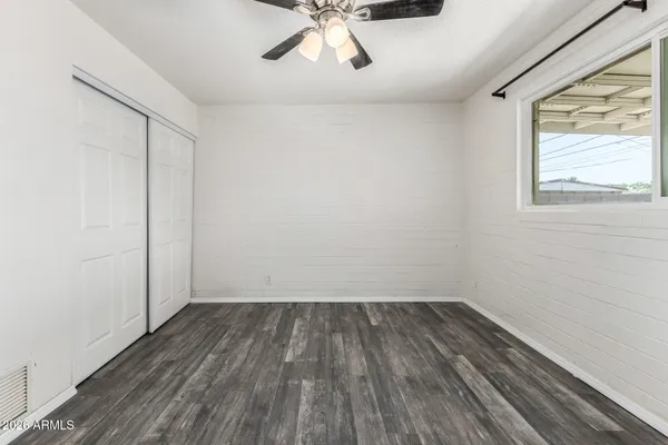 wooden floor in an empty room with a window