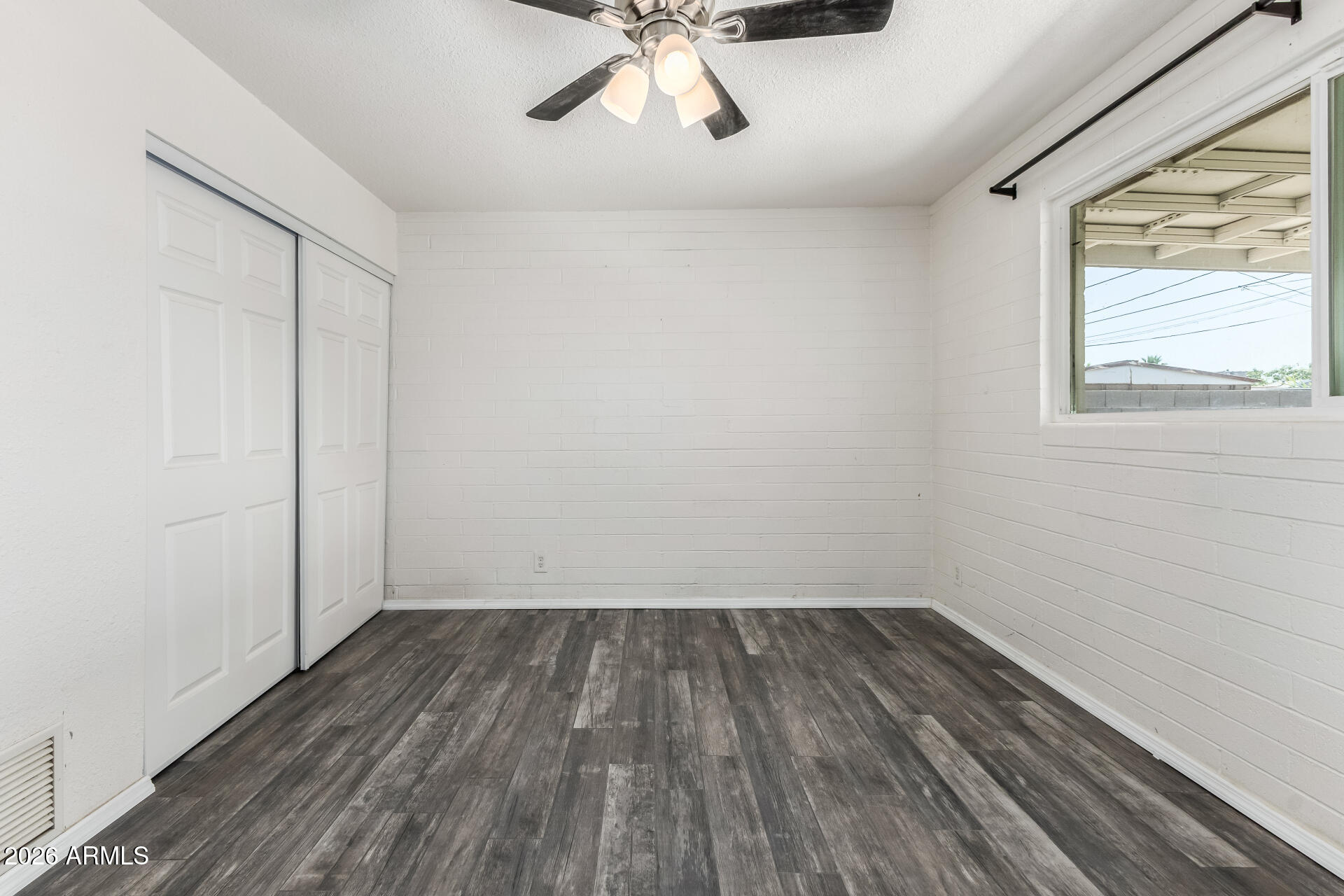 801 East Ruth Avenue Phoenix, AZ 85020 - Photo 16 of 35 wooden floor in an empty room with a window