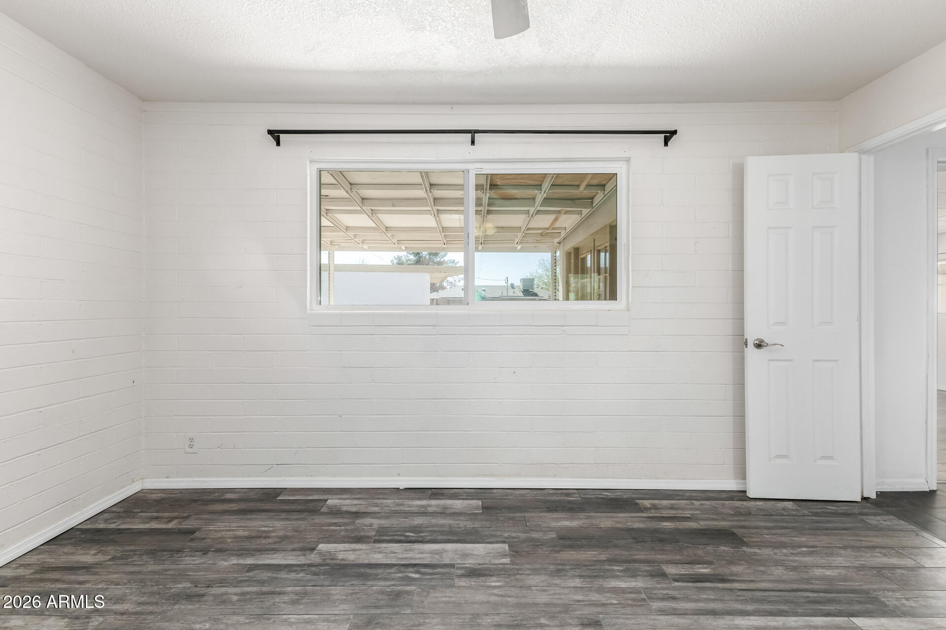 801 East Ruth Avenue Phoenix, AZ 85020 - Photo 17 of 35 a view of an empty room with wooden floor and a window