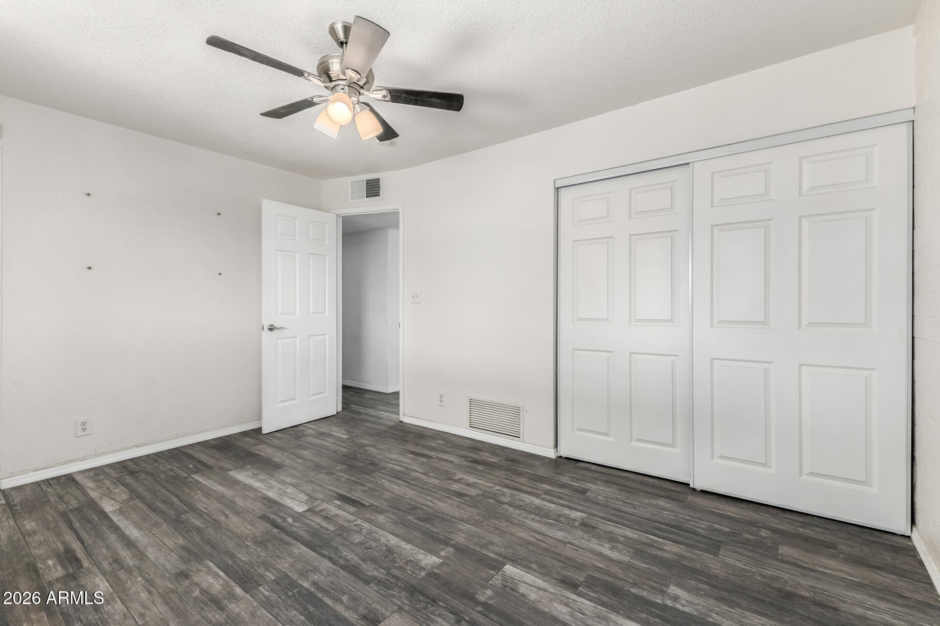 801 East Ruth Avenue Phoenix, AZ 85020 - Photo 18 of 35 an empty room with wooden floor and ceiling fan