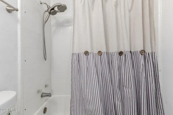 a bathroom with a shower curtain and a sink