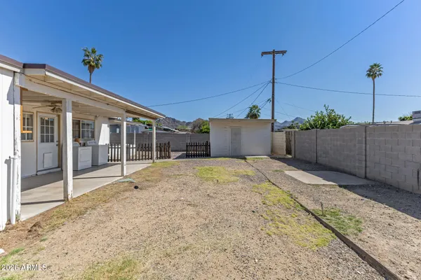 a view of backyard with wooden fence