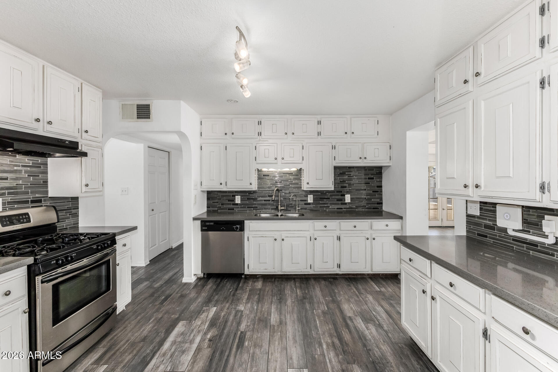801 East Ruth Avenue Phoenix, AZ 85020 - Photo 4 of 35 a kitchen with granite countertop a sink stainless steel appliances and cabinets