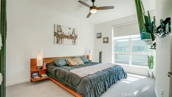 a bedroom with a bed and a flat screen tv