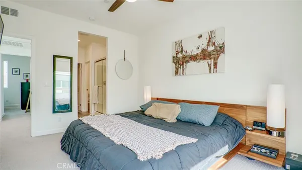 a bedroom with a bed and a flat tv screen