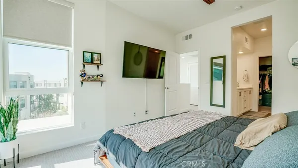 a hallway with white cabinets and entryway