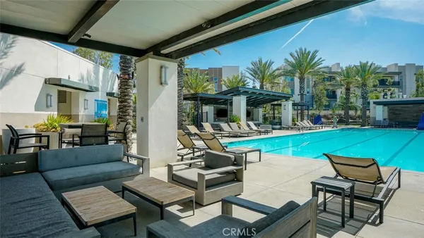 a lawn chairs sitting in a yard with swimming pool