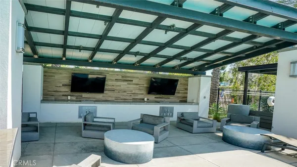 a view of a house with swimming pool and sitting area