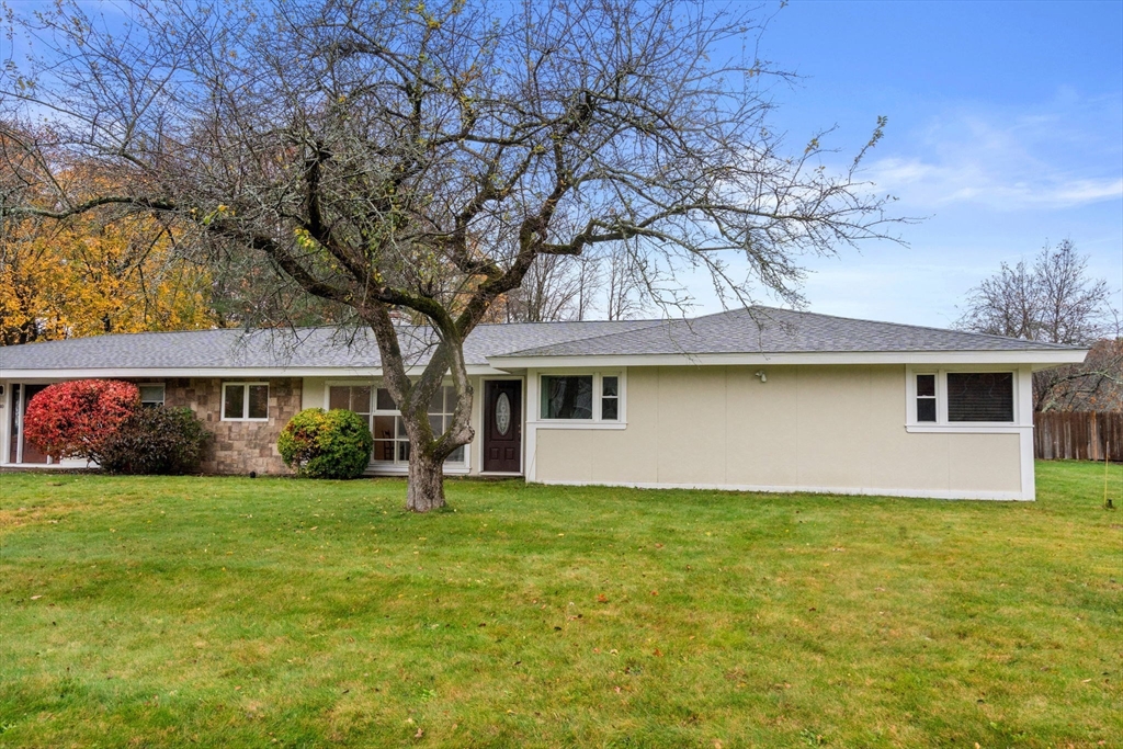 a house that has a big yard with large trees