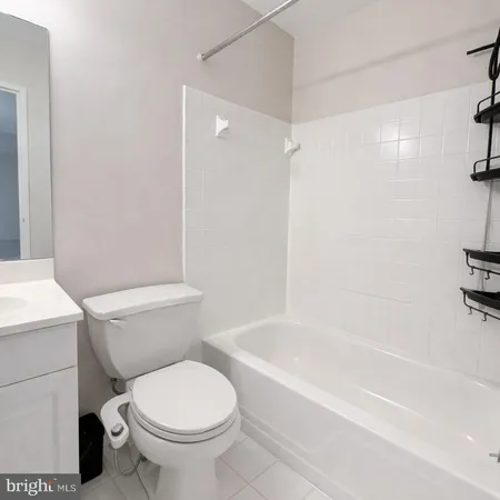 a bathroom with a toilet and a bathtub