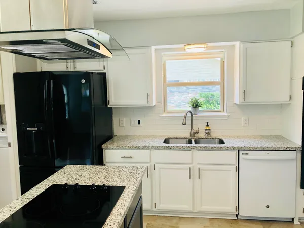 a kitchen with a sink stove and cabinets