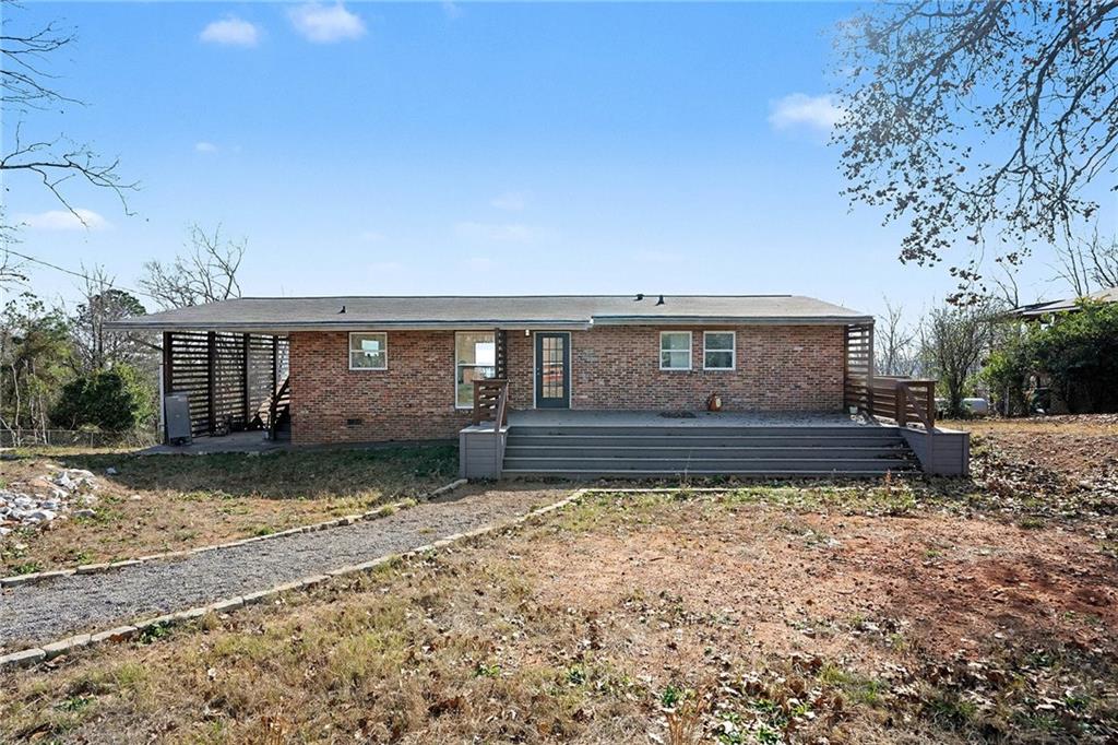 a view of house with backyard and sitting area