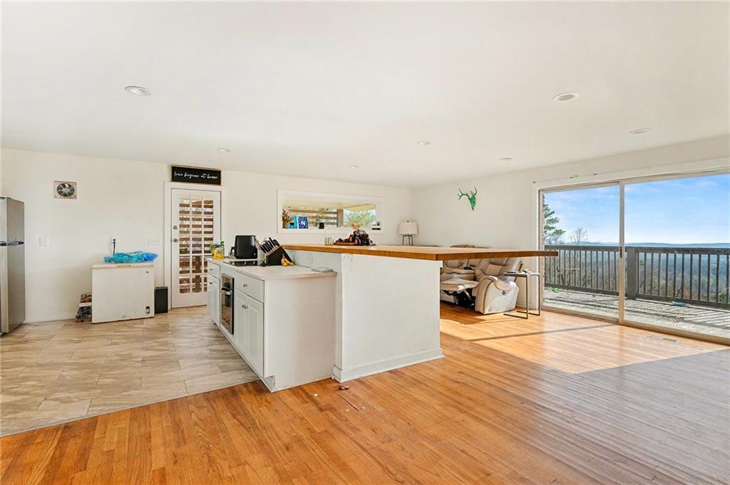 6900 Scenic Heights Road Manchester, GA 31816 - Photo 6 of 30 a living room with stainless steel appliances kitchen island granite countertop a sink and cabinets