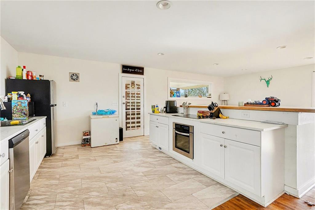 6900 Scenic Heights Road Manchester, GA 31816 - Photo 7 of 30 a kitchen with white cabinets and appliances