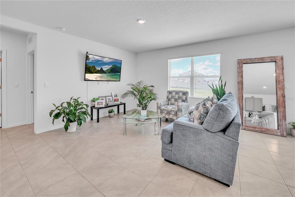 8237 Juning Cove Wesley Chapel, FL 33545 - Photo 11 of 59 a living room with furniture potted plant and a window