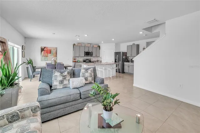 a kitchen with stainless steel appliances granite countertop a stove top oven a sink a microwave and a refrigerator