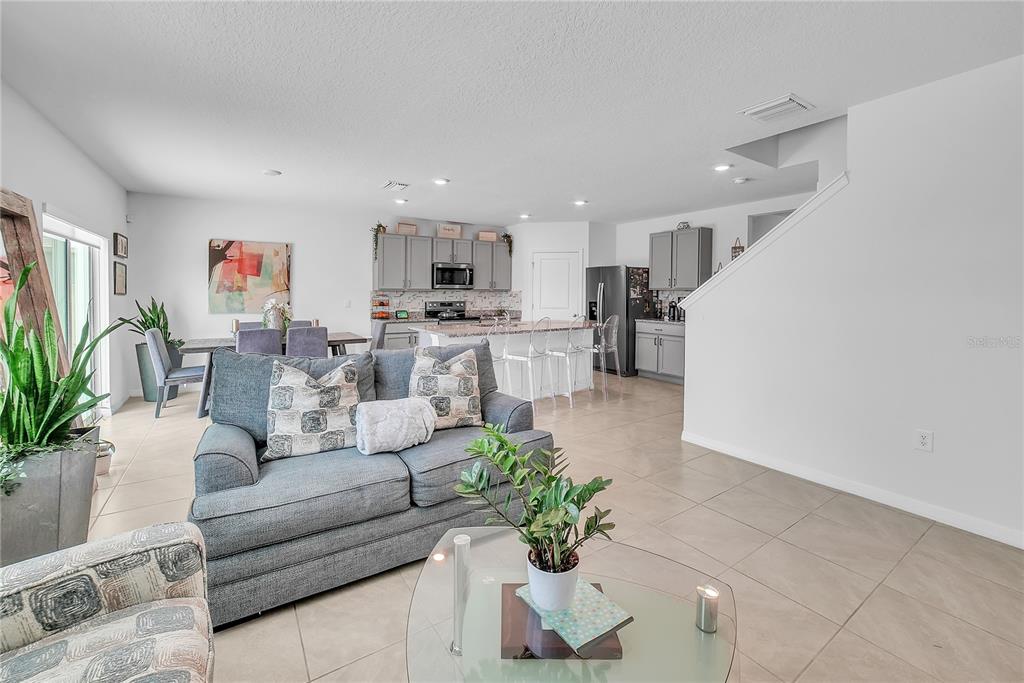 8237 Juning Cove Wesley Chapel, FL 33545 - Photo 12 of 59 a living room with furniture and a flat screen tv