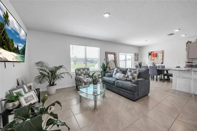 a kitchen with stainless steel appliances granite countertop a stove top oven a sink a refrigerator and a granite counter tops