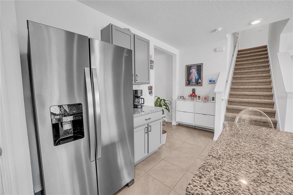 8237 Juning Cove Wesley Chapel, FL 33545 - Photo 21 of 59 a kitchen with stainless steel appliances a refrigerator and a stove