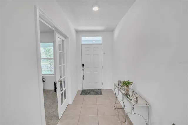 a view of a hallway with windows and entryway