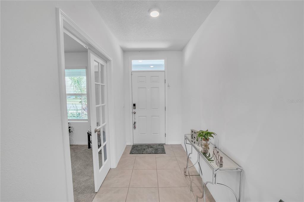 8237 Juning Cove Wesley Chapel, FL 33545 - Photo 22 of 59 a hallway with sliding door and yard
