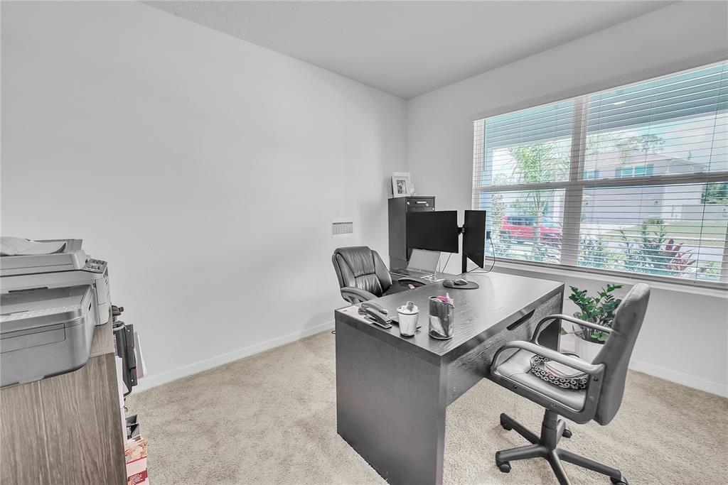 8237 Juning Cove Wesley Chapel, FL 33545 - Photo 24 of 59 a view of a workspace with furniture and a window