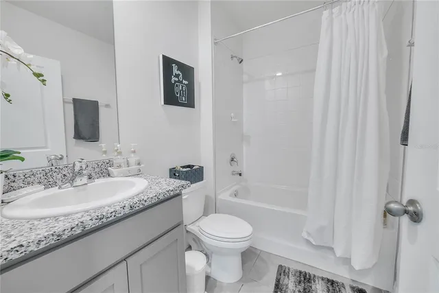 a spacious bedroom with a bed and a window