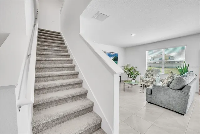 a spacious bedroom with a bed and a couch