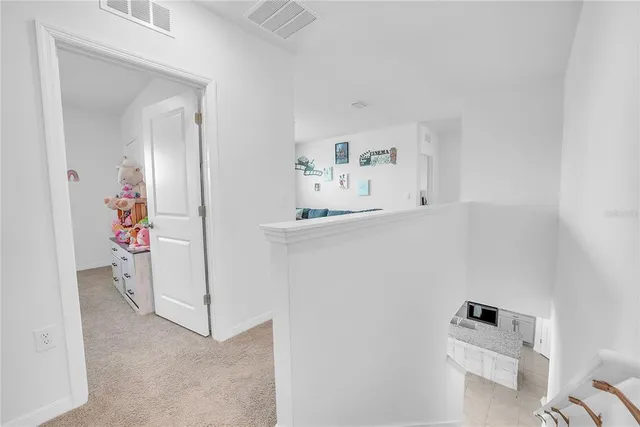 a view of walk in closet with clothes