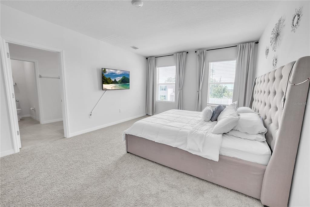 8237 Juning Cove Wesley Chapel, FL 33545 - Photo 30 of 59 a bedroom with a bed and a window