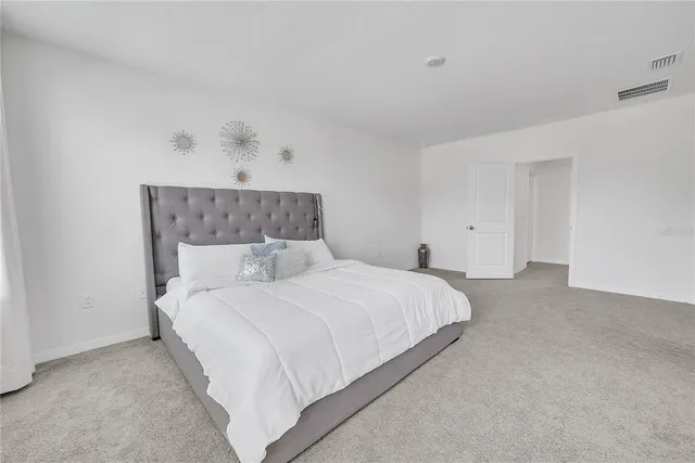 a bedroom with a bed and a table